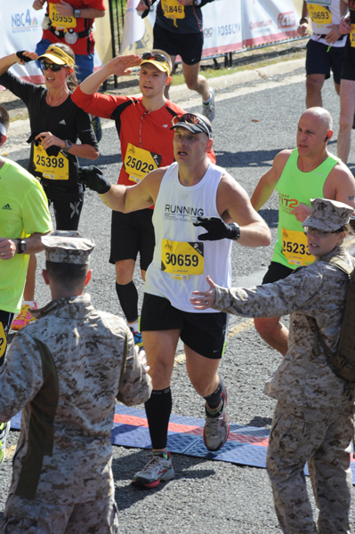 Saluting the Marines as we crossed the (crowded) finish line