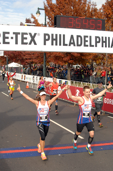 Crossing the finish in our 50 States Marathon club vests